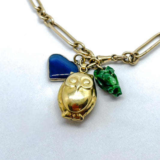 Jewellery can be seen as a visual storybook - here is a Charm Pendant Necklace with three charms a blue stone gifted by a close Friend, an owl from a trip to Vanuatu, and a botanical inspired carved piece of Jade from Singapore