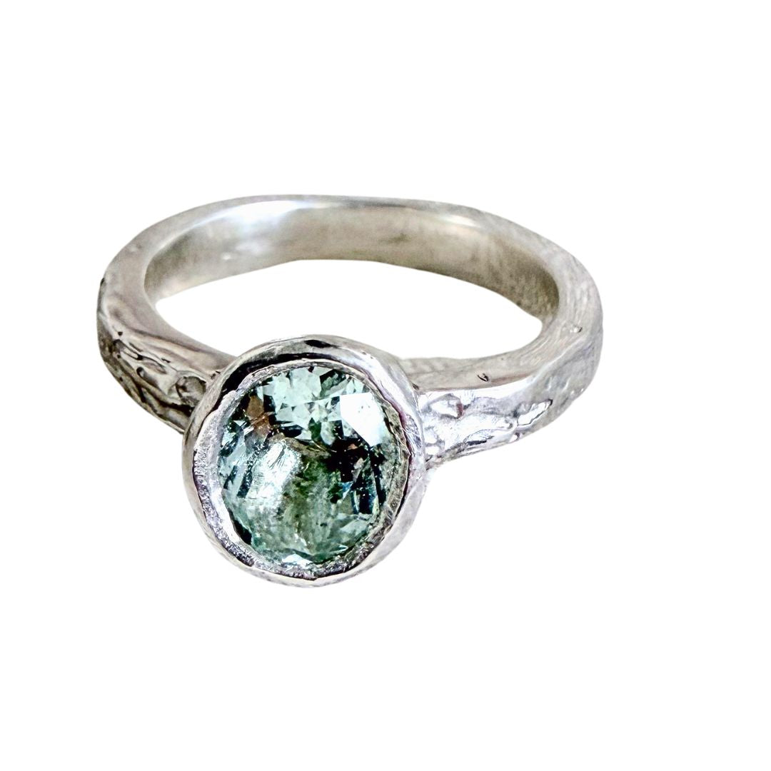 Manatū Ring in sterling silver with an oval natural aquamarine, textured handmade band and organic bezel setting.