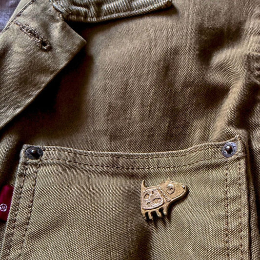 Bronze Dog Pin worn on the pocket of a khaki Levi's Jacket