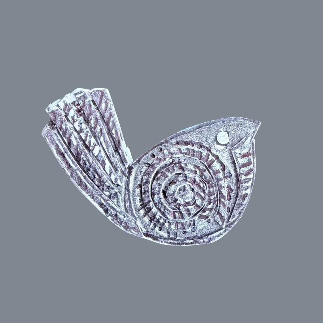 Textured bird pin design made using layered collage shapes and carved line details.