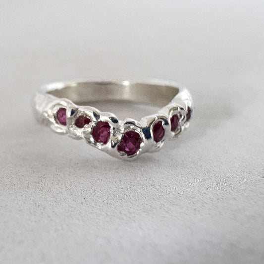 The Arc Ruby Ring in Sterling Silver front facing showing the rubes along the front of the band forming the distinctive V of the Tiara band