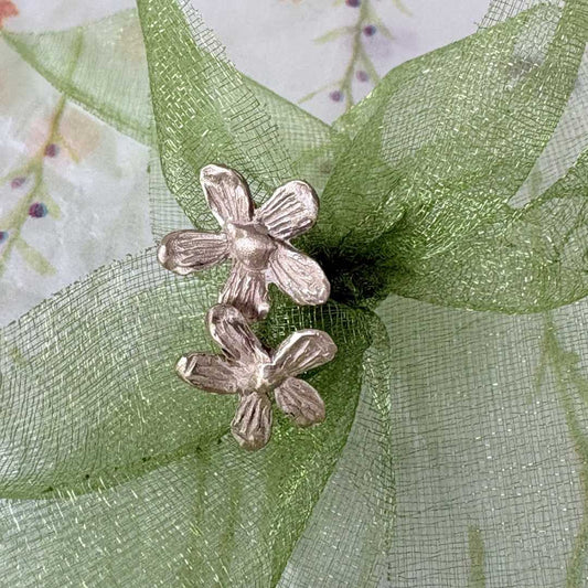 Flora Stud Earrings - 9ct yellow gold flower studs on green tulle ribbon with floral paper background - spring styling