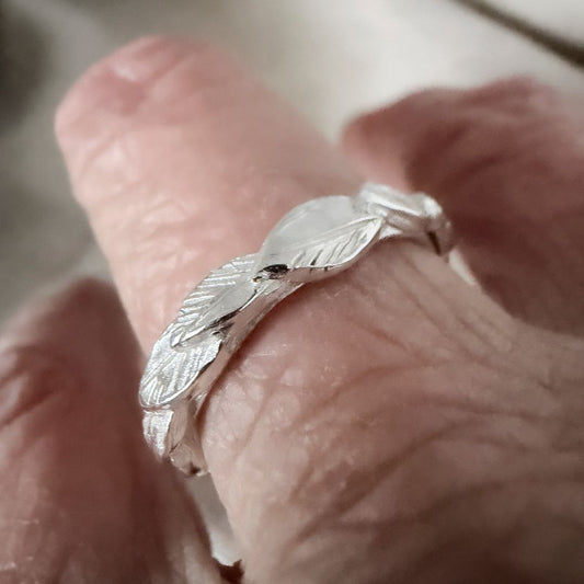Sterling silver Organic Leaf Stacking Ring worn on the finger, showing its overlapping leaf design.