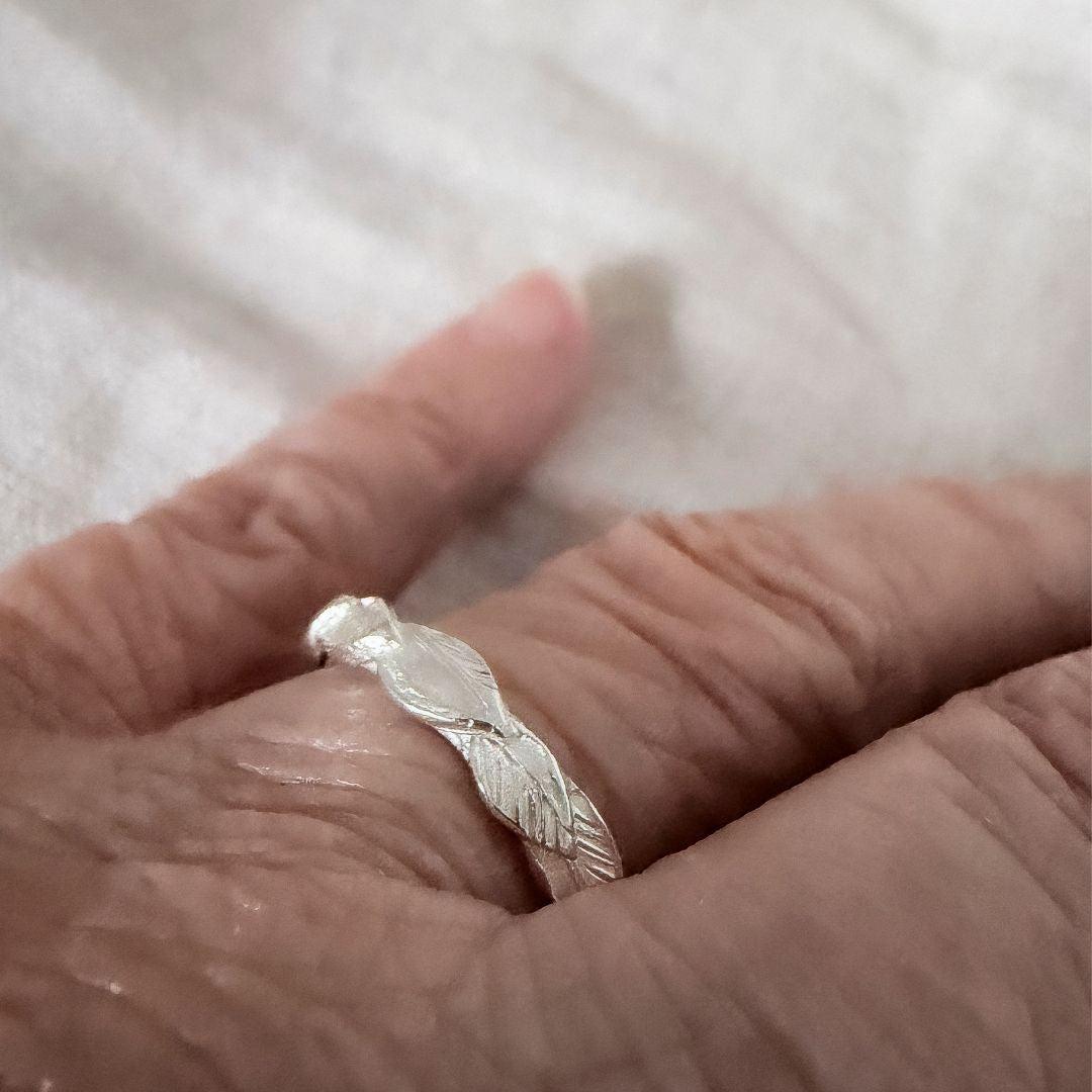 Sterling silver Organic Leaf Stacking Ring worn on the hand, highlighting the layered leaf texture and slim organic band.