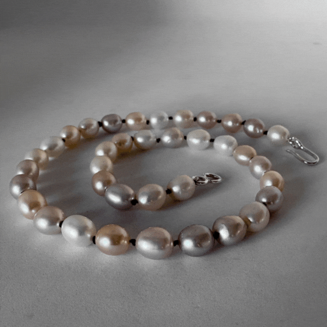 Animated view of HerbertandWilks freshwater pearl necklace showing full strand, clasp detail, and styled look