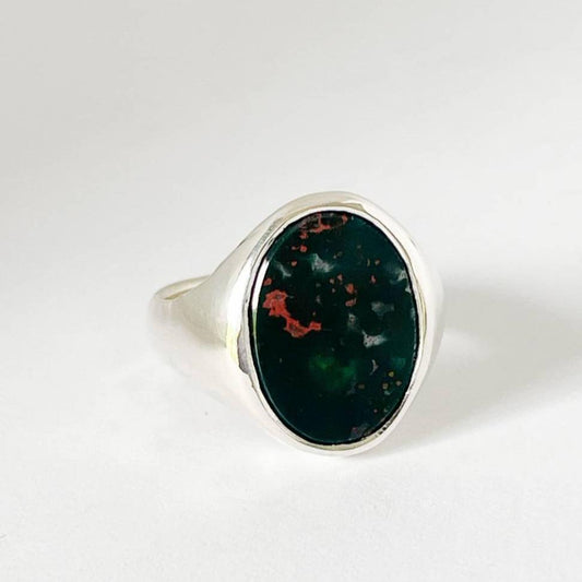 Front profile of handcrafted silver Bloodstone Signet Ring with deep green cabochon and prominent red splashes, photographed on white background – HerbertandWilks Jewellery