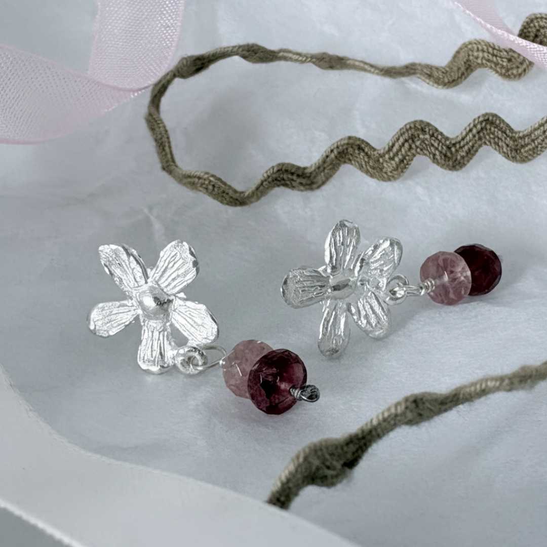 Flora Drop Earrings with Pink Tourmaline โ detailed view showing organic sterling silver flower texture and pink tourmaline beads