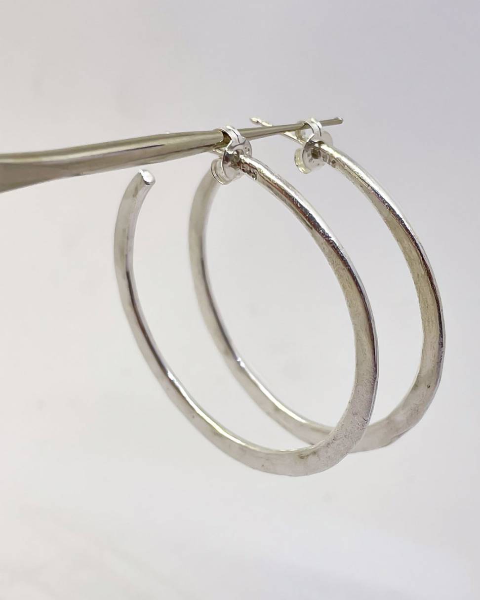 A pair of Sterling Silver Lunar Hoops showing the side profile