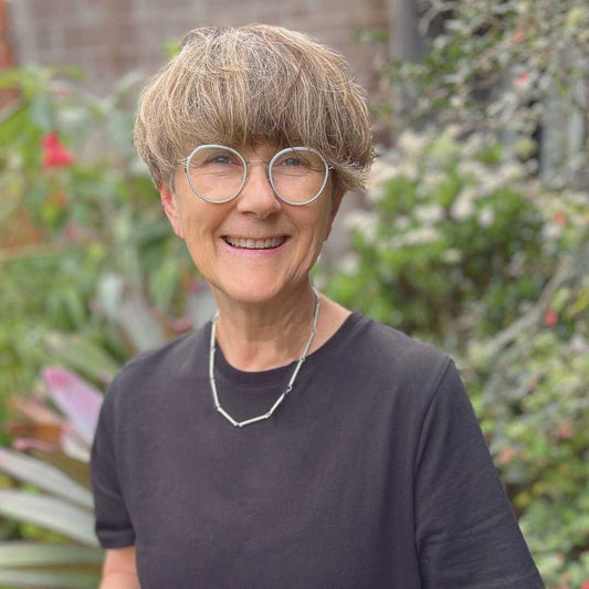 Woman wearing Line Chain Necklace showing how it sits below the collarbone in everyday wear