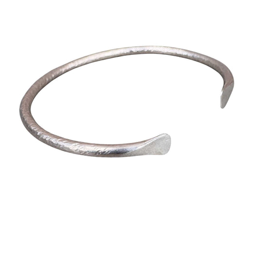Maker Cuff – hand-forged sterling silver cuff with subtle texture, shown on a white background