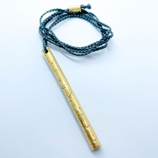 Close-up of gold-plated pendant showing organic surface texture