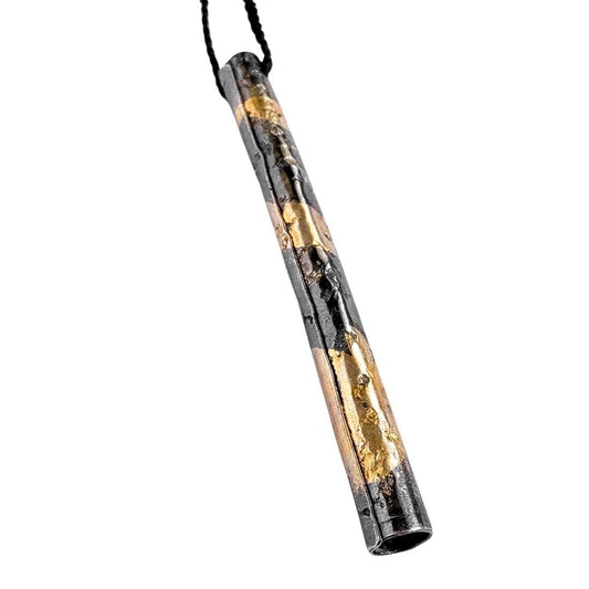 Close-up of sculptural Wrapped pendant showing basalt-textured fine silver and Keum-Boo gold detail.