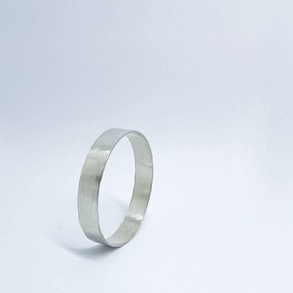 A heavy organic textured Sterling Silver Bangle