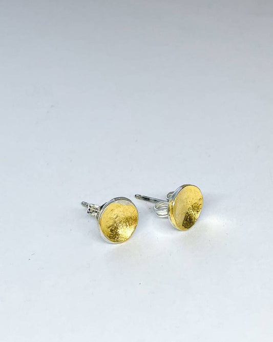 A pair of organic Fine Silver concave Stud Earrings with a Silver+Gold Finish
