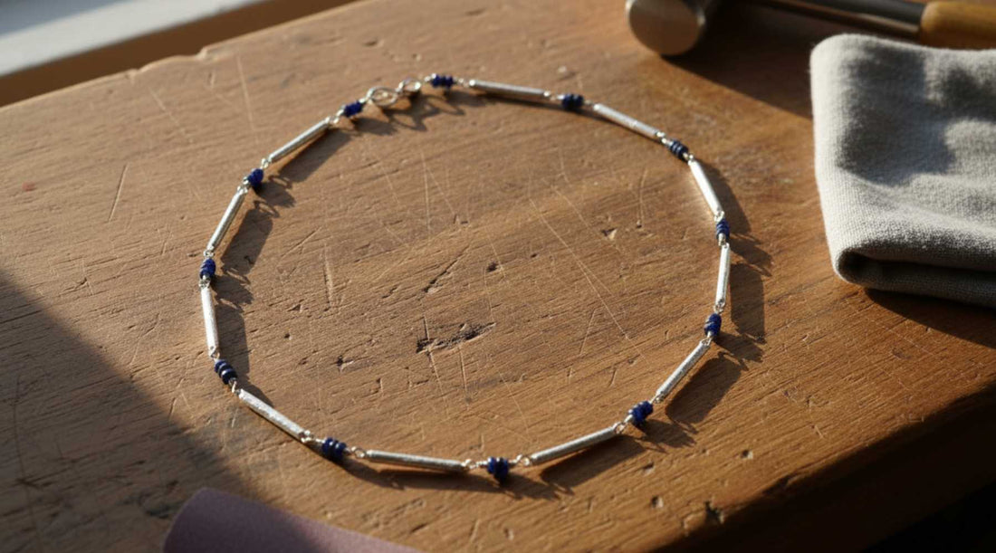 Line chain necklace with blue sapphires on jeweller's bench - everyday jewellery