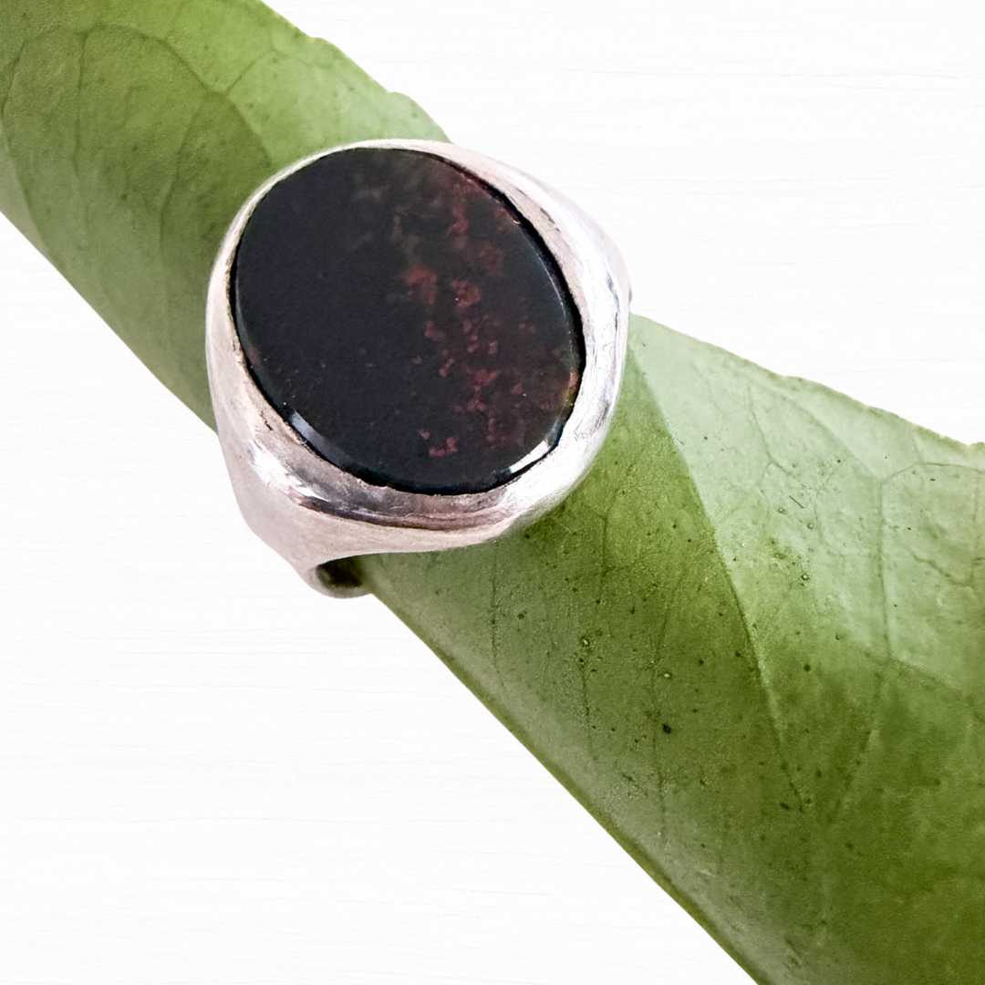 Front profile of handcrafted silver Bloodstone Signet Ring with deep green cabochon and prominent red splashes, photographed on white background – HerbertandWilks Jewellery