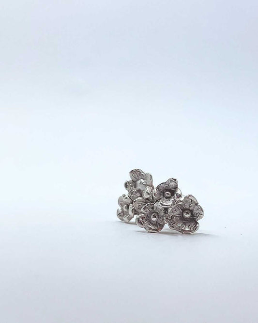 A front view of a pair of Sterling Silver Flower bouquet Stud Earrings made of 3 Flowers each earring.