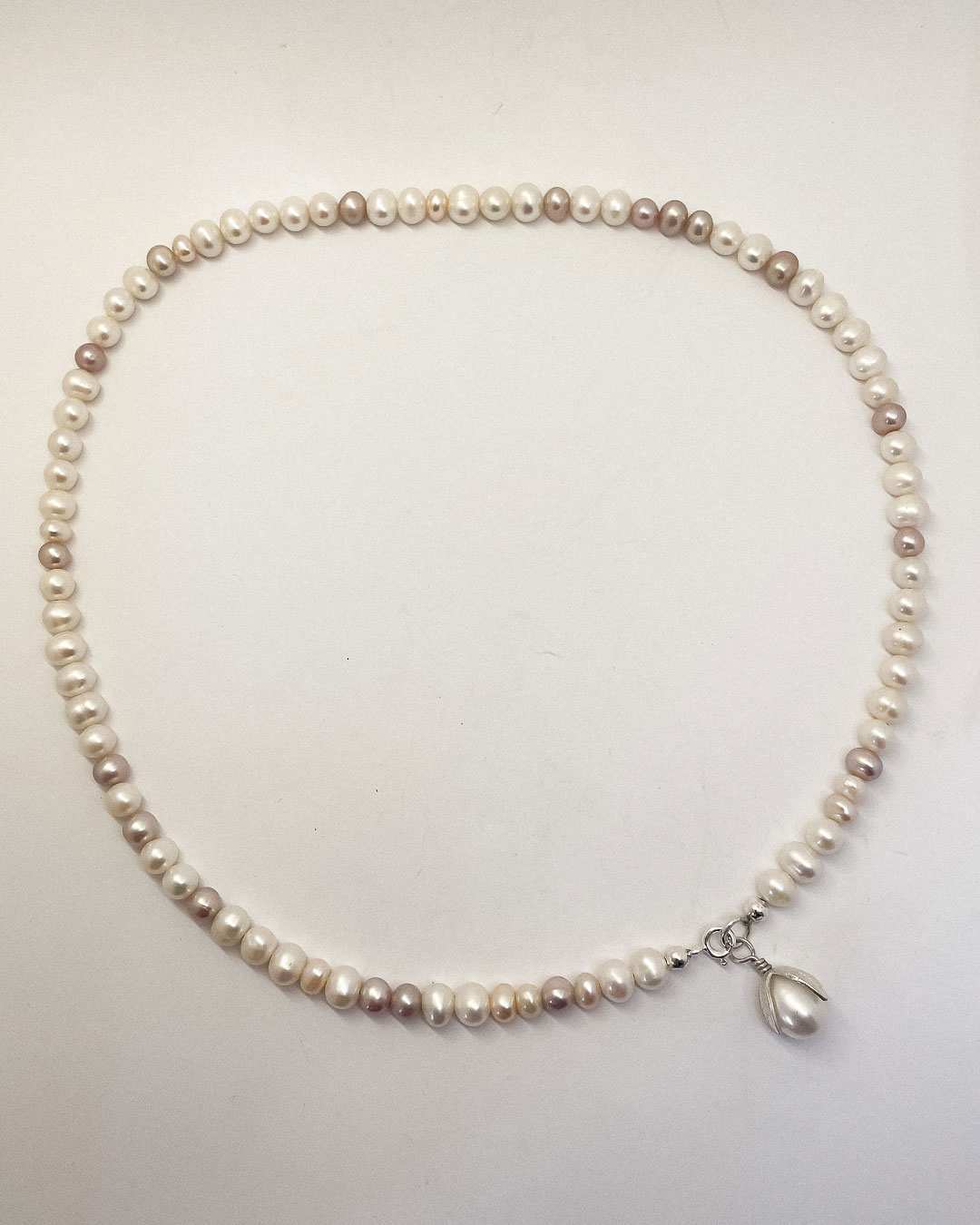 A one-of-a-kind Glow Rice Pearl Mixed Necklace is crafted with Organically-sized round and oval-shaped freshwater pearls - each with their own unique, colour, shape and characteristics with a Pearl pendant