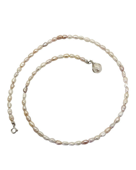 A one-of-a-kind Glow Rice Pearl Mixed Necklace is crafted with irregularly-sized rice-shaped freshwater pearls - each with their own unique, colour, shape and characteristics  with a Pearl pendant
