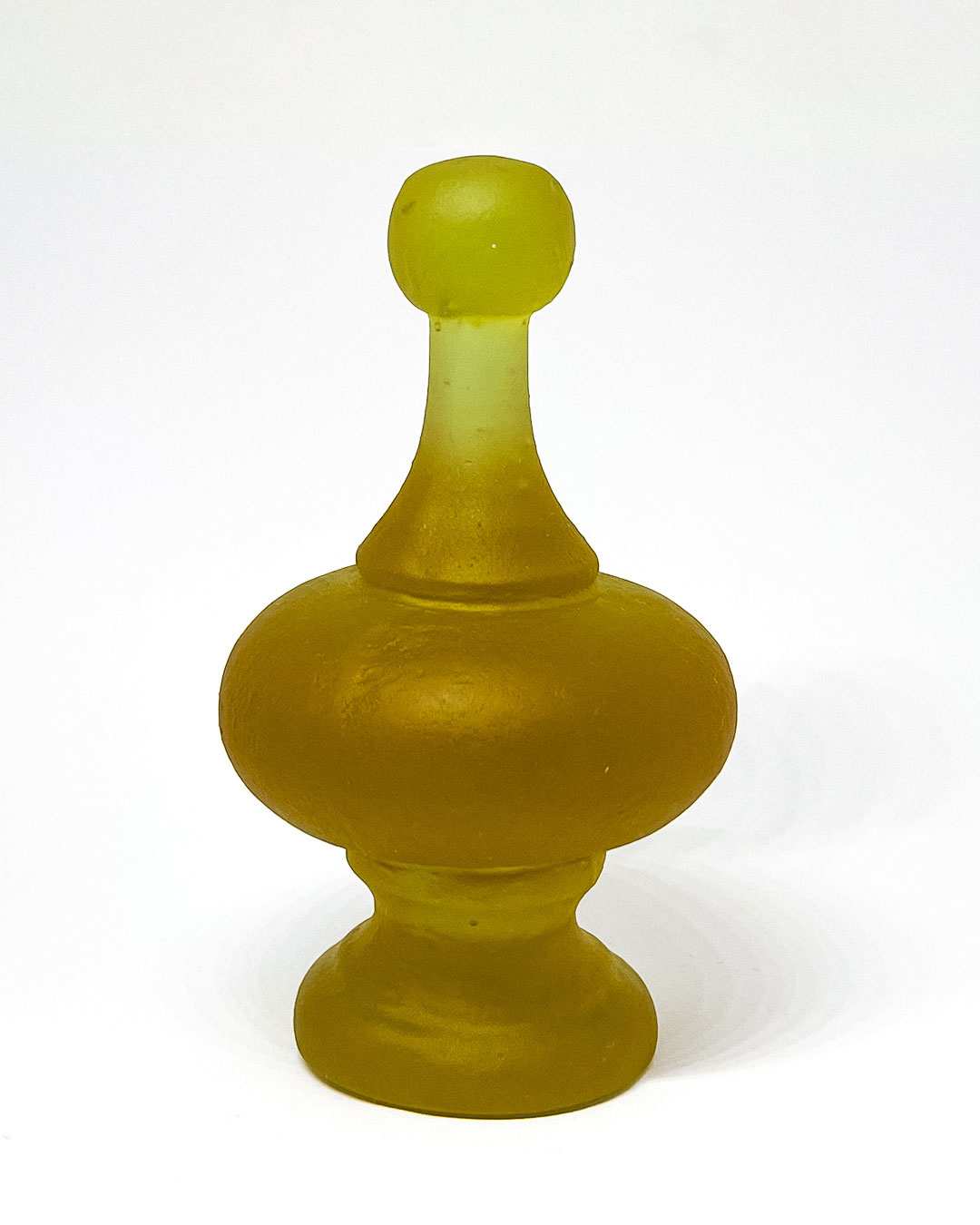 A Rhubarb Cast Glass Finial  lit to showcase the alternative green colour