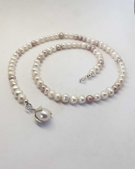 A one-of-a-kind Glow Rice Pearl Mixed Necklace is crafted with Organically-sized round and oval-shaped freshwater pearls - each with their own unique, colour, shape and characteristics with a Pearl pendant
