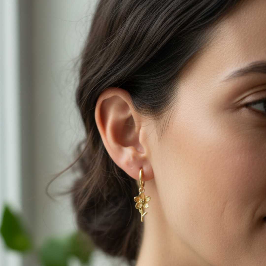 Woman wearing 12mm 9ct gold sleeper earring with Flora charm - personalized everyday gold hoops
