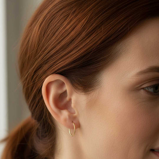 Woman wearing 12mm 9ct gold sleeper earring - comfortable everyday gold hoop