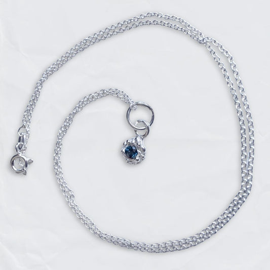 Fine sterling silver Dewdrop pendant featuring a natural blue sapphire gemstone, displayed on a clean background.
