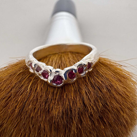 The Arc Ruby Ring in Sterling Silver balancing on a brush showing a colour contrast
