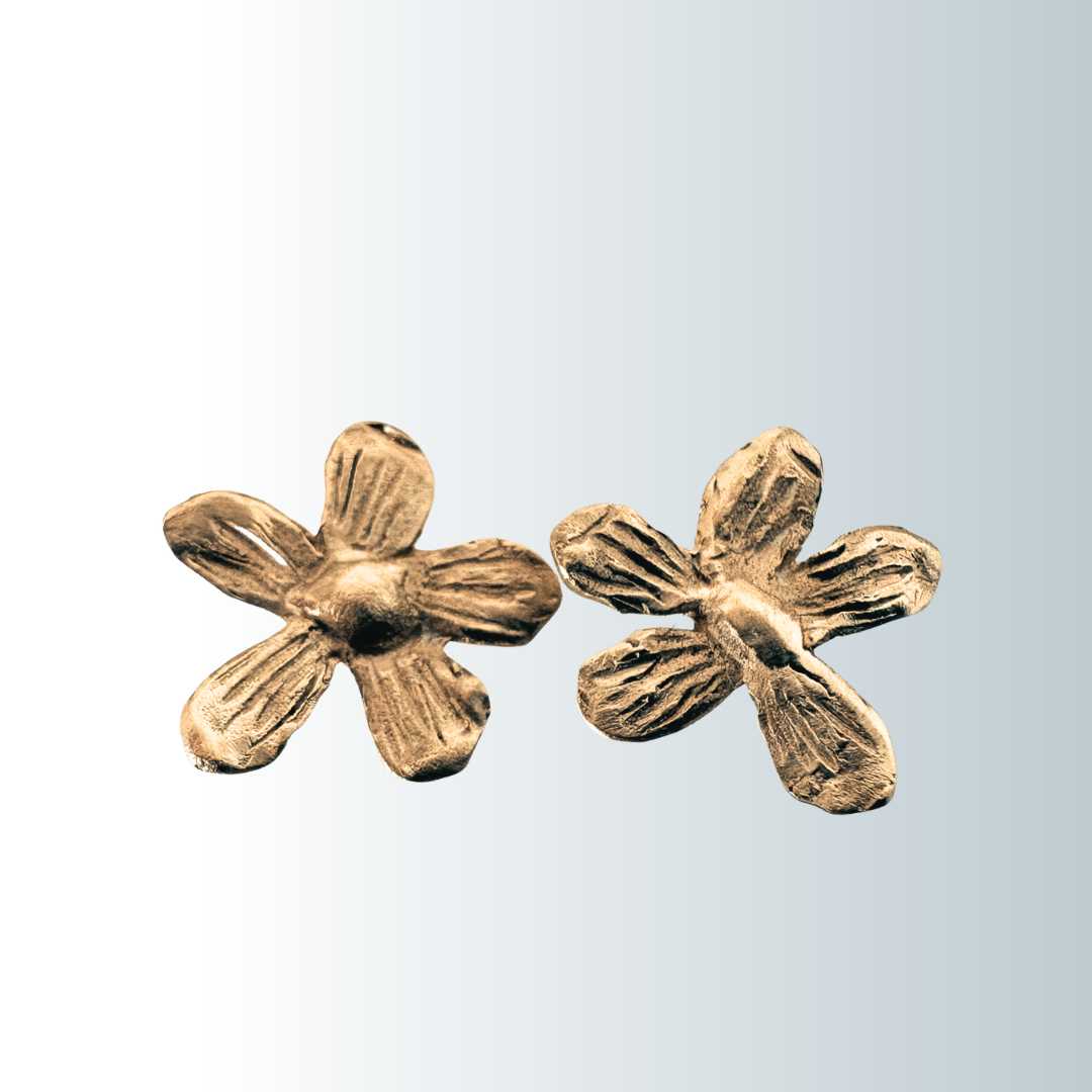 Flora Stud Earrings in 9ct yellow gold - hand-finished flower studs with sculptural petals on smokey blue and white background