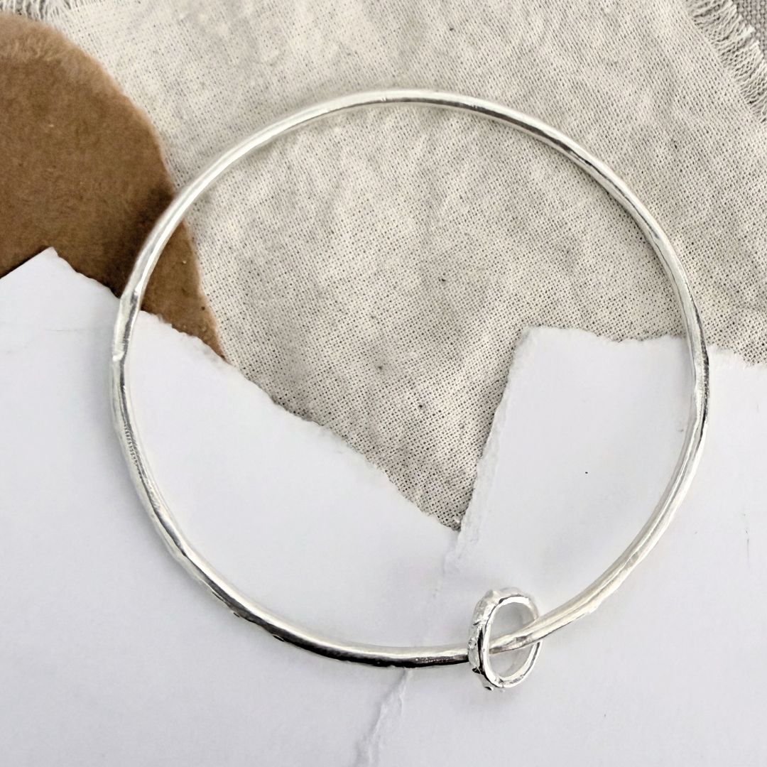 Sterling silver Fluid Ring Bangle with organic round profile and loose sculpted ring detail