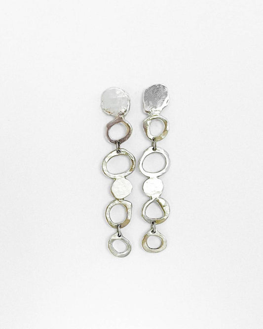 Showing the front of a pair of contemporary-designed drop earrings are inspired by the graceful fall of raindrop in Sterling Silver