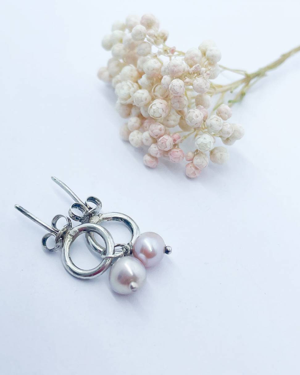 Handcrafted Abstract Circle Earrings with Pearl Charms on a pale background, showcasing the unique design and silvery-pink freshwater pearls.