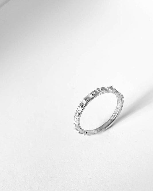 A Narrow Textured Stacking Ring with a primitive organic textured surface in sterling silver