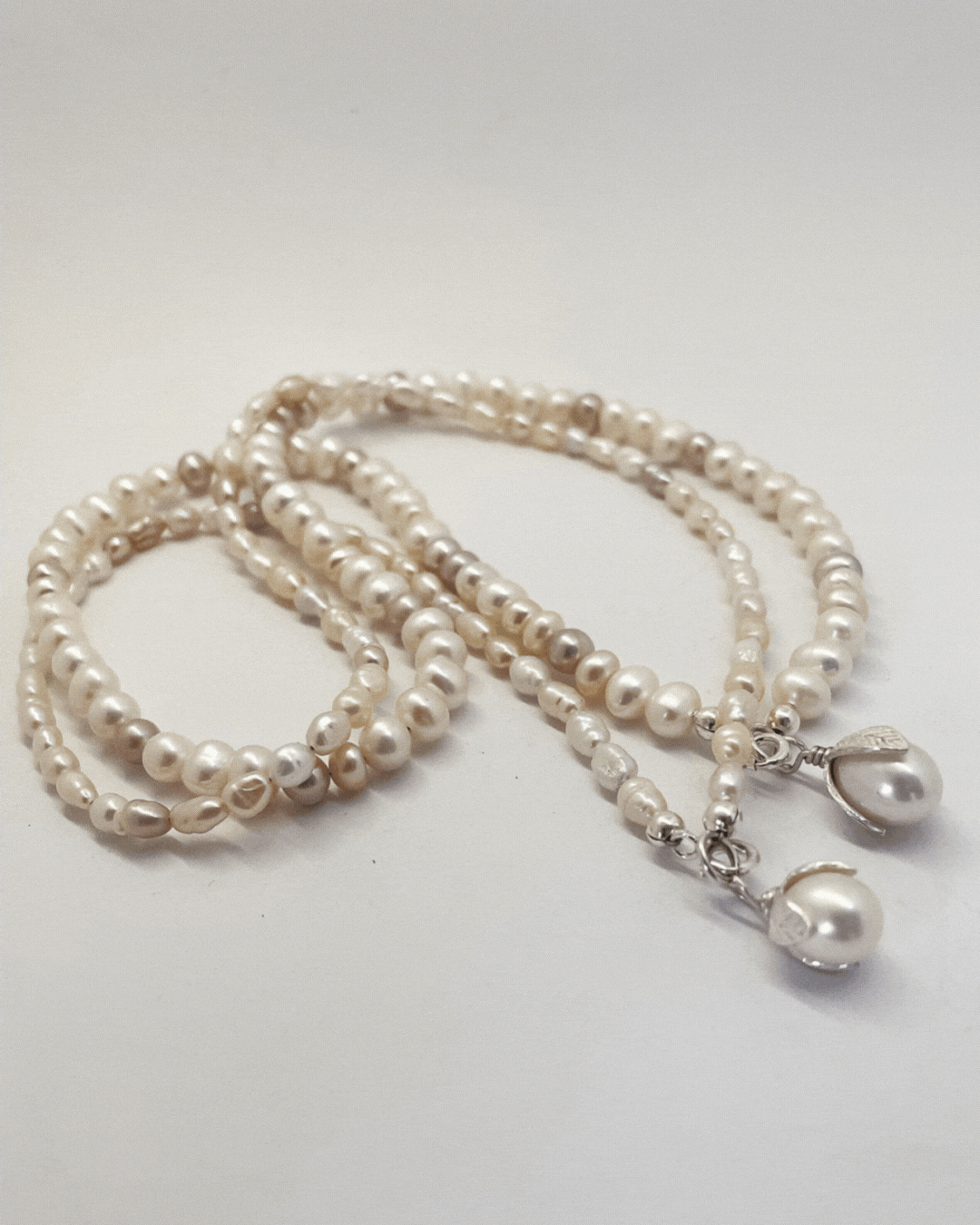A short video showing two one-of-a-kind Glow Pearl Necklaces  with a Pearl pendant