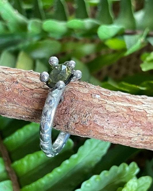 My Shades of Green Ring is a freeform prong ring is set with green tourmaline. Band width 2mm Weight is 3.5 grams (approximately) This ring is size L in Sterling Silver with a matte finish. (In Stock)