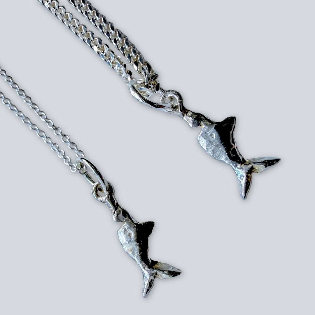 Close-up of Mini Chomp sterling silver fish pendant with cable and diamond-cut curb chain options.
