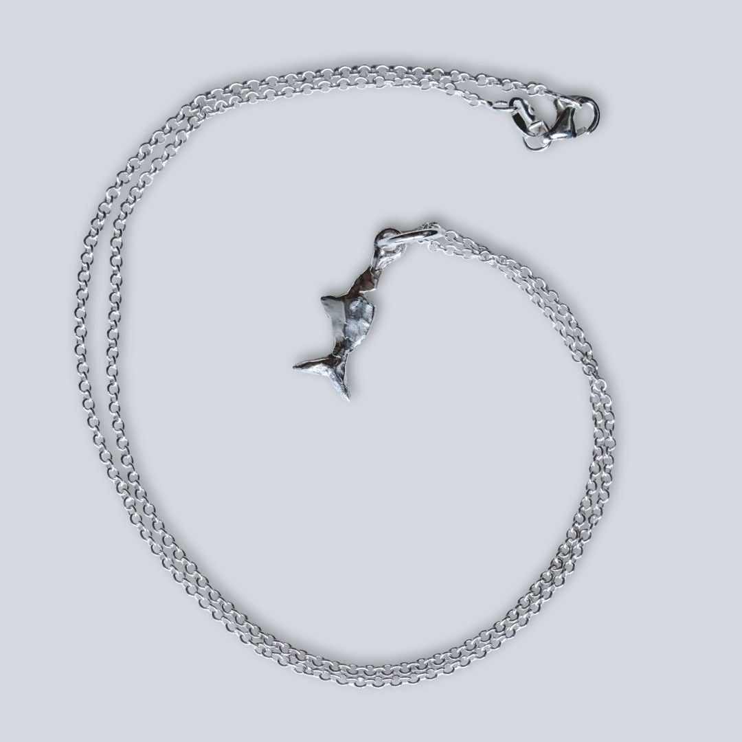 Mini Chomp fish pendant with sterling silver cable link chain and lobster clasp, arranged on a pale background.