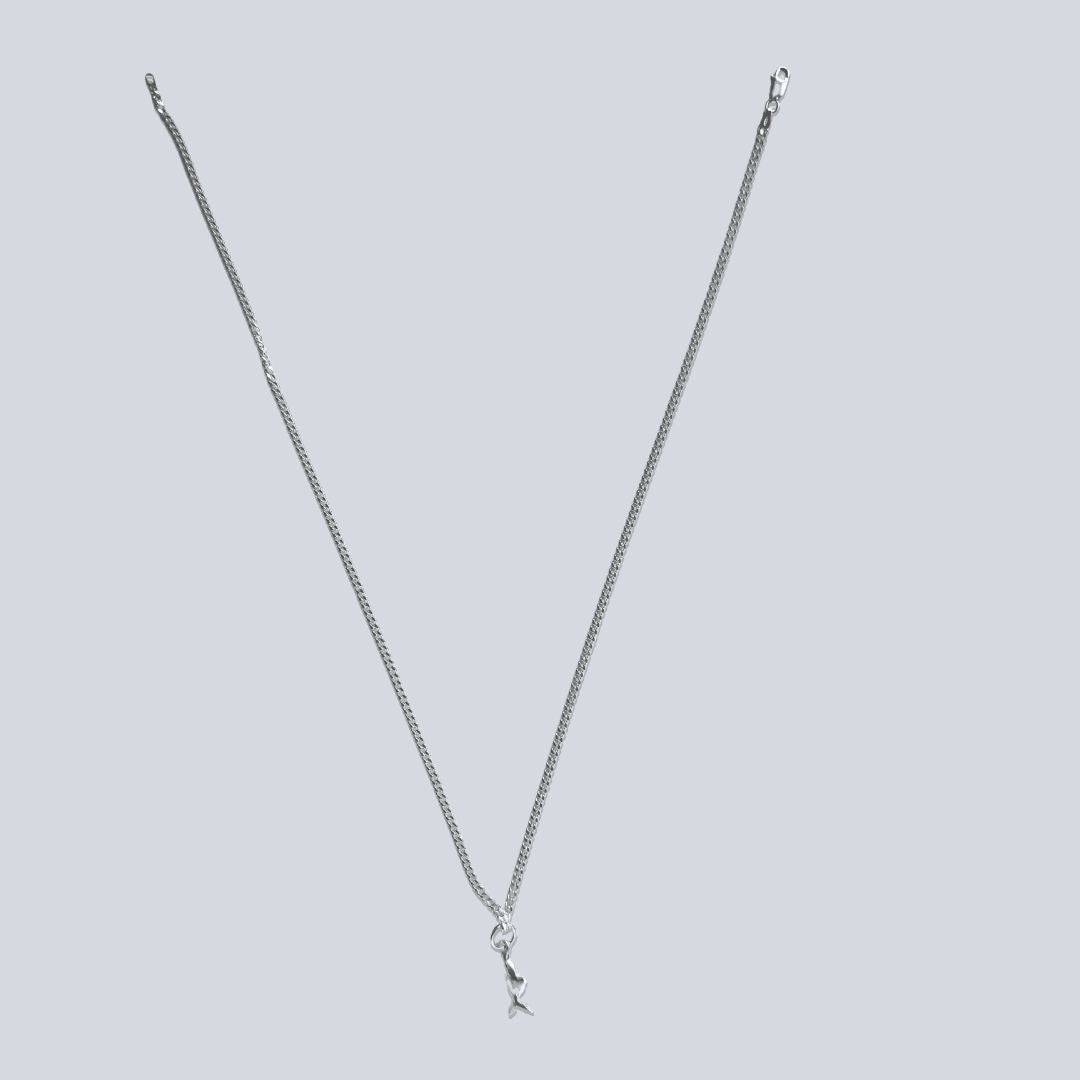 Mini Chomp sterling silver fish pendant on 50cm diamond-cut curb chain, shown at full necklace length.