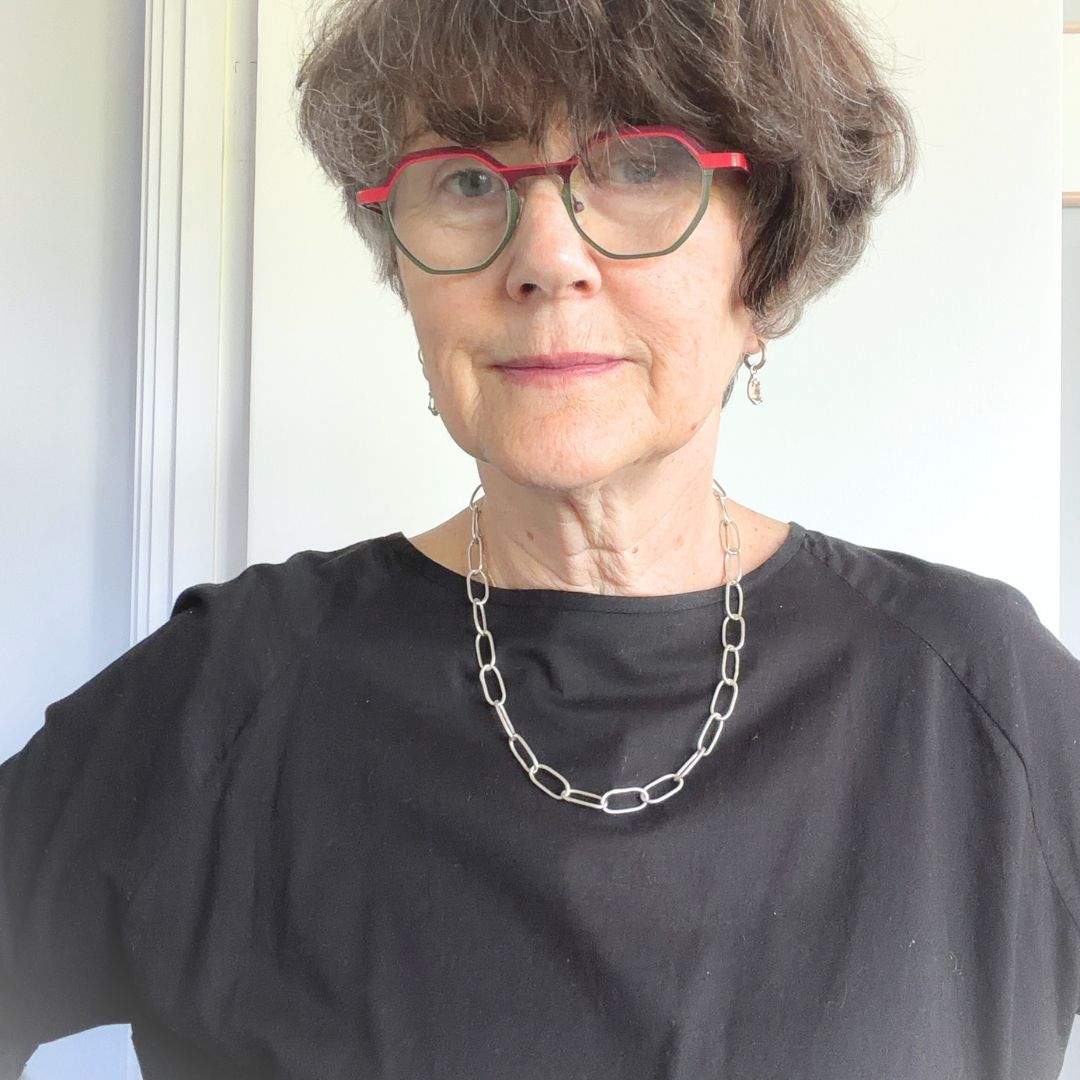 20-inch handmade sterling silver Oval Link Chain necklace worn over a black top, showing the elongated links and how the necklace sits on the chest.