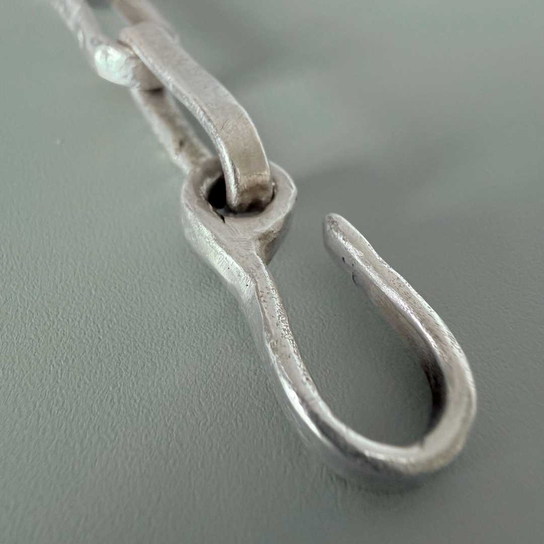 Close-up of hand-cast sterling silver paperclip chain hook and obround link – HerbertandWilks Jewellery Auckland