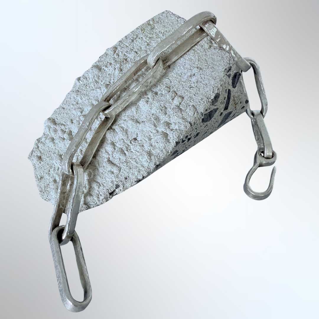 Sterling silver paperclip chain bracelet draped on concrete – made to measure, handmade in Mt Eden Auckland