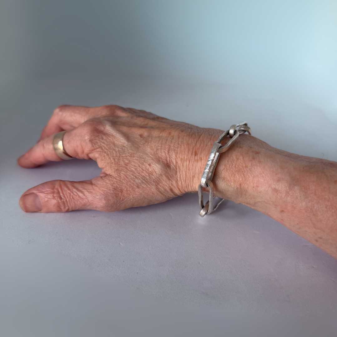 Oversized sterling silver paperclip chain bracelet worn on maker's wrist – unisex handmade chain, HerbertandWilks Jewellery Mt Eden Auckland