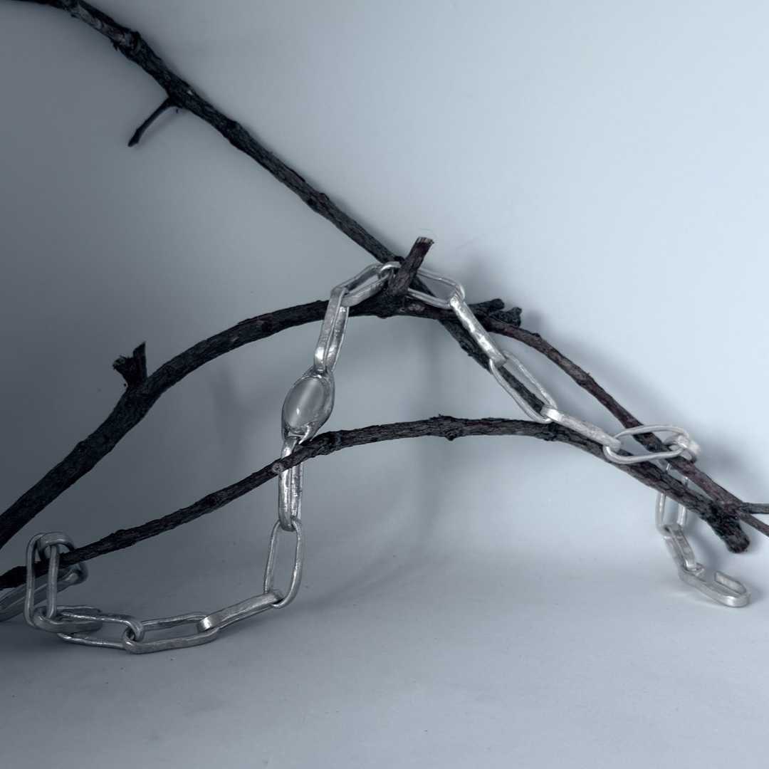 Sterling silver paperclip chain necklace with moonstone bezel draped over branches — handmade in Mt Eden, Auckland by HerbertandWilks