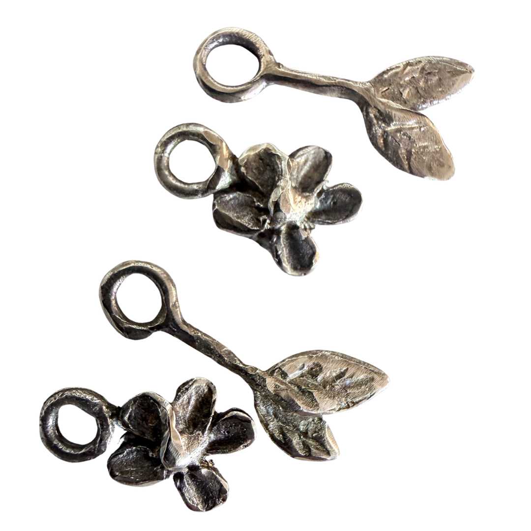 Handcrafted bronze Plum Blossom & Leaf earring charm set by HerbertandWilks Jewellery, including two flower and two leaf charms. This four-piece local Auckland jewellery set is shown on a white background.