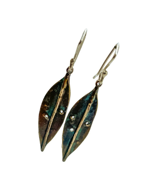 A pair of Pohutukawa Leaf Pendant Earrings made from patinaed Bronze + Sterling Silver