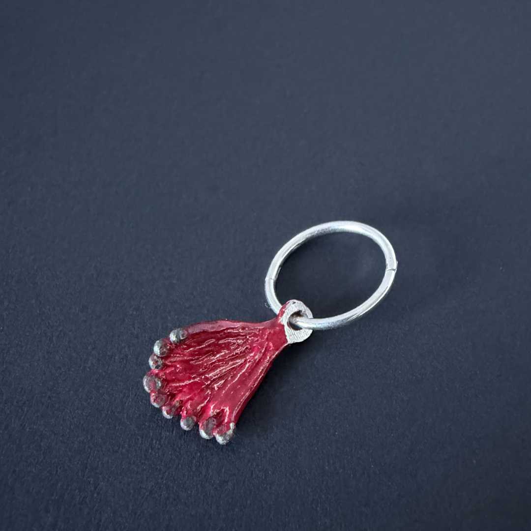Single Pohutukawa charm earring on a 12mm sterling silver sleeper. Ideal for asymmetric styling or adding to an ear stack.