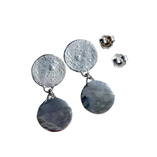 Front view of the 35mm length sterling silver Sequin Disc Dangle Earrings alongside their stabilising butterfly backings on a clean white background, showcasing the dual-textured artisan design.