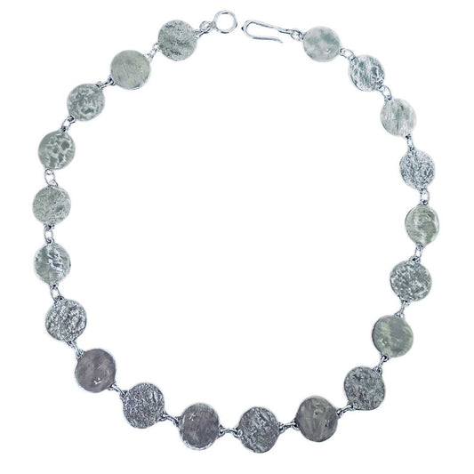 Handcrafted 48cm sterling silver Sequin Disc Necklace arranged in a full circle against a seamless white background, showcasing the repeating three-texture artisan pattern and clasp findings.