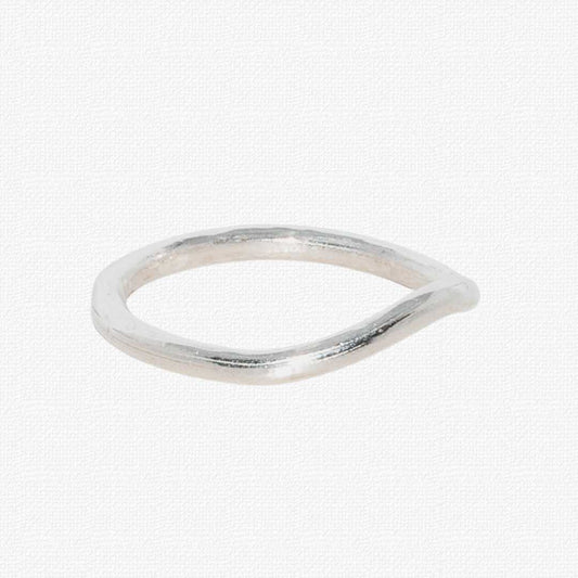A sterling silver Sylvan Band ring shown at an angle to highlight its hand-sculpted wishbone curve, resting on a textured background.